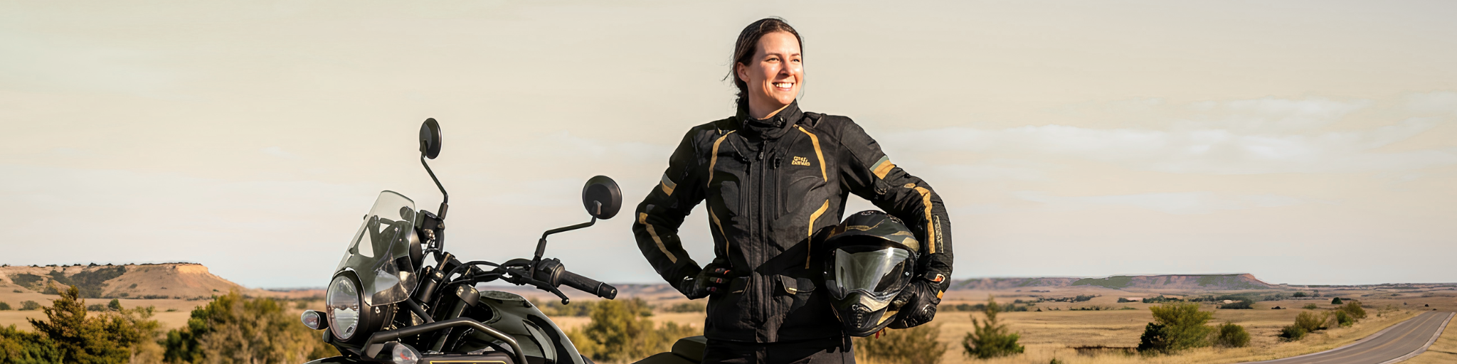 Woman motorcycle rider in full gear standing next to her motorcycle in Oklahoma City, representing the growing community of women riders in the OKC area.